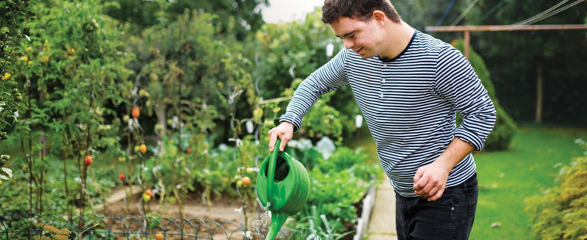 boy watering garden