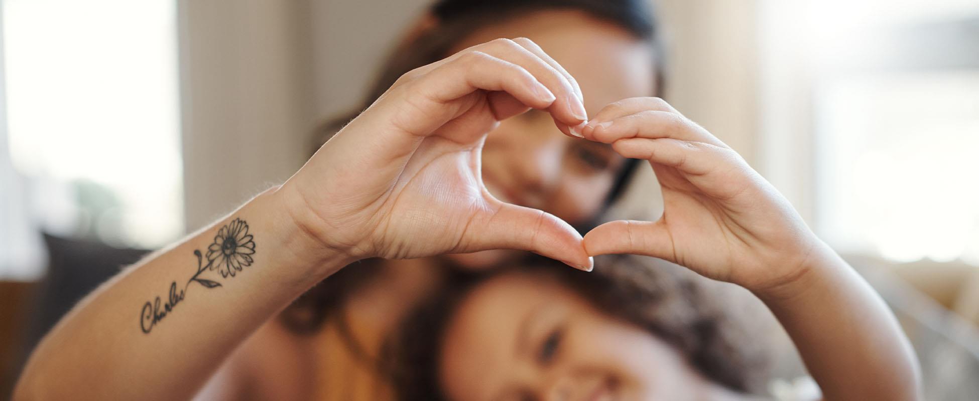 mother and child making love heart shape with hands